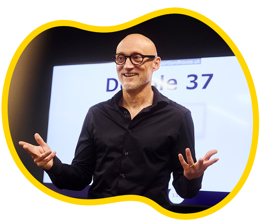 Photo of Ben presenting in front of a whiteboard.