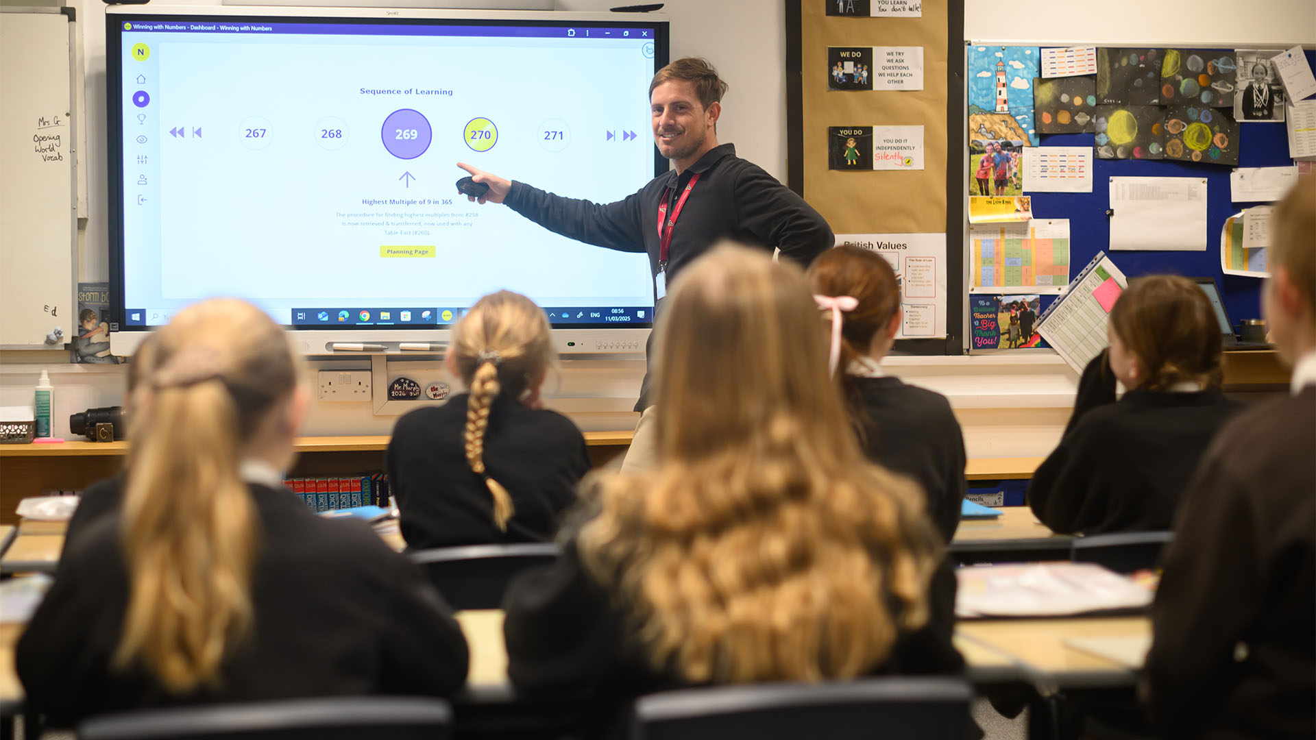 Teacher at whiteboard working with pupils
