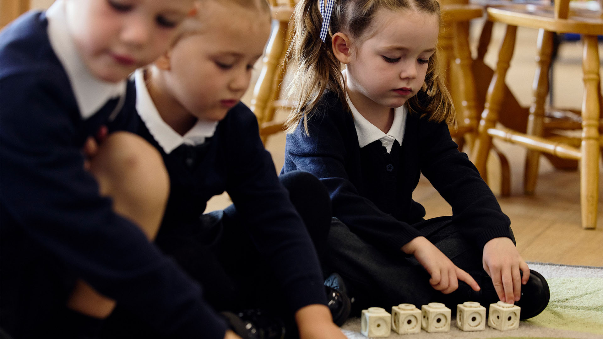Three pupils working with blocks