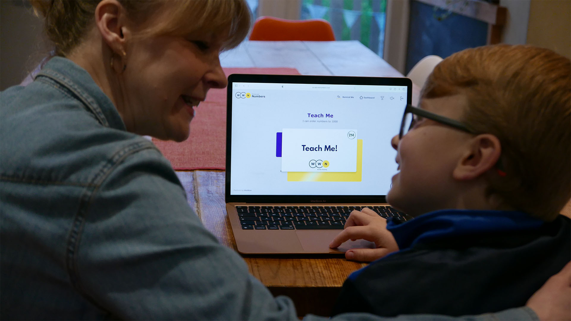 Tutor and pupil working on a laptop